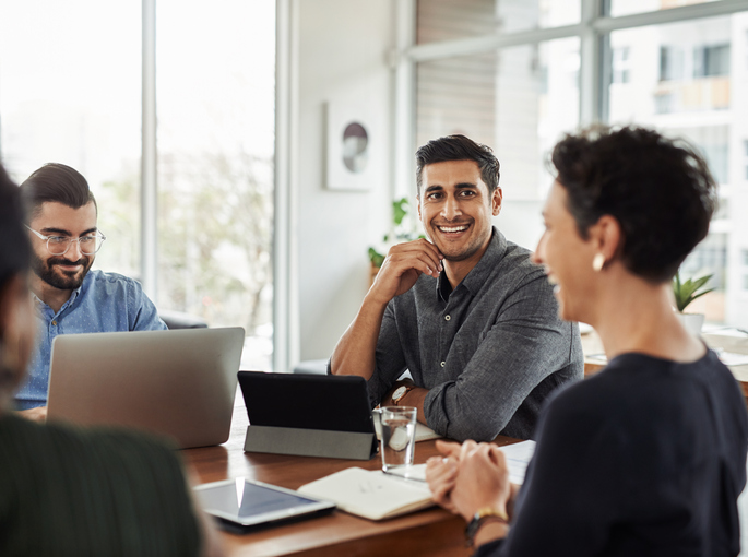 people in conference room smiling